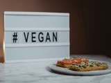 Teller mit Broten, dahinter Aufschrift vegan