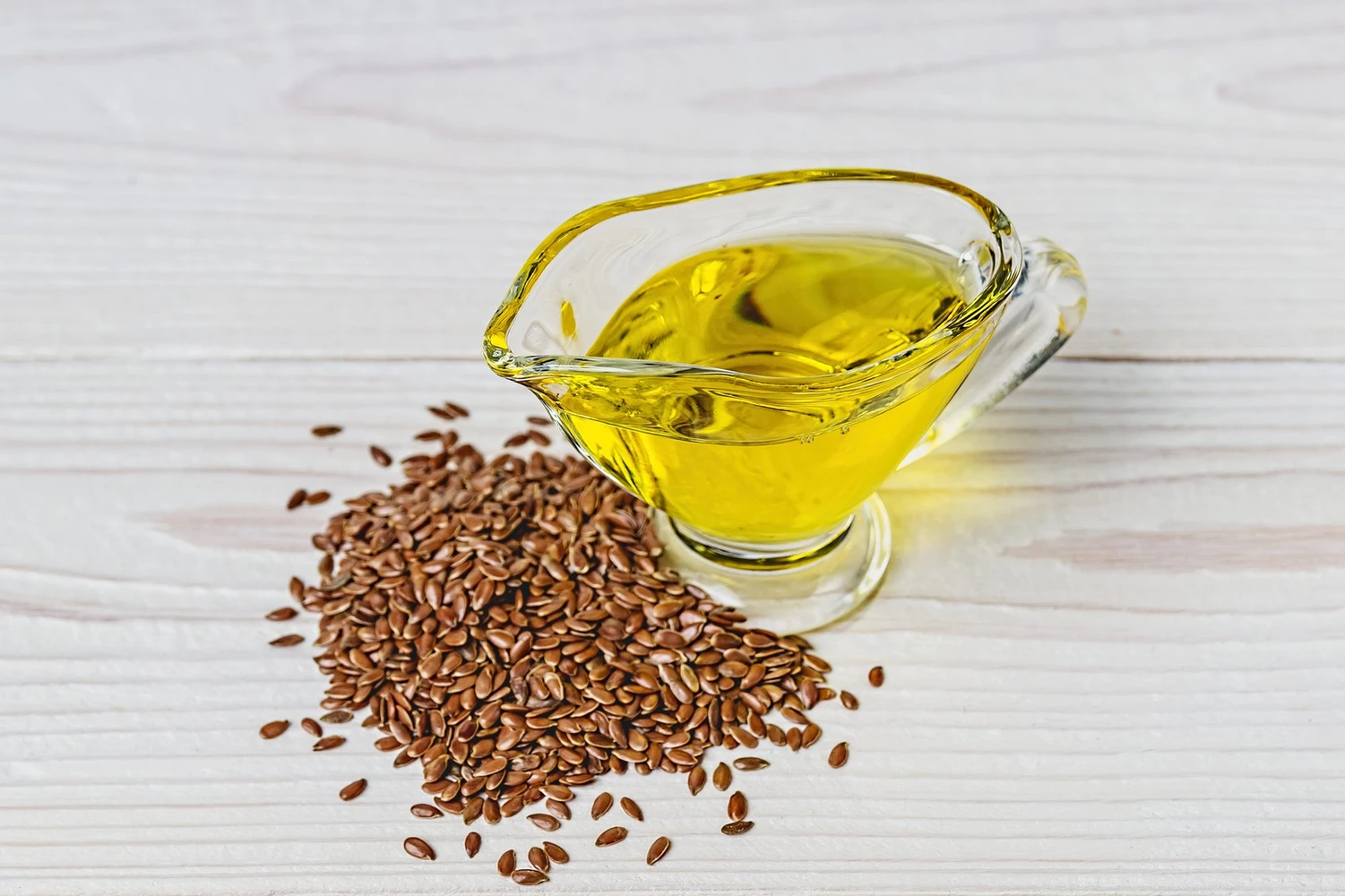 flaxseed-oil-glass-gravy-boat-flax-seeds-white-surface_0.jpg